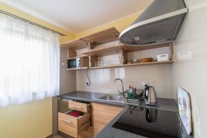 a small kitchen with a sink and a microwave at Agroturystyka "U Dyzia" in Kielce