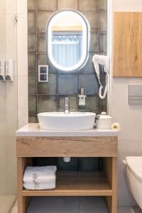 a bathroom with a sink and a mirror at Villa 16 Zakopane in Zakopane