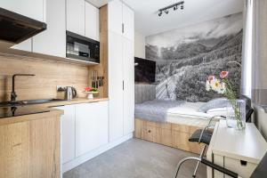 a small kitchen with a bed in a room at Villa 16 Zakopane in Zakopane