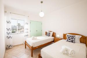 a bedroom with two beds and a window at Albufeira - 3 bedrooms - free wifi in Albufeira