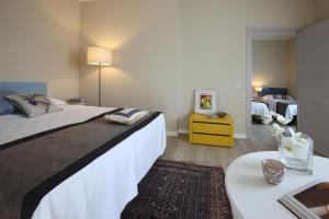 a bedroom with a large bed and a desk with a table at Hotel Ca' Mura in Bardolino