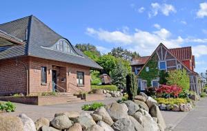 a group of houses with rocks in front of them at Ferienwohnungen am Hafen in Seedor in Sandort