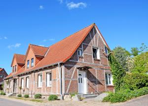 an old brick house with an orange roof at Fewos 1 4 in Seedorf am Hafen Haus in Seedorf