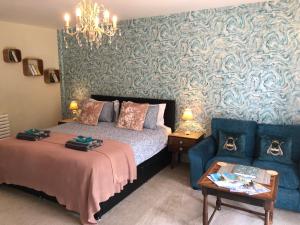 a bedroom with a bed and a couch at Little Treasure with up to 25 percent off ferry in Shanklin