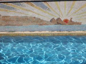 a painting of a pool of water with a ship at Acogedor apartamento en l'Estartit in L'Estartit