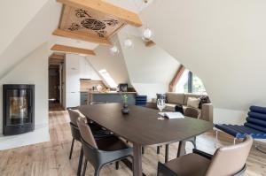 a dining room and living room with a table and chairs at Villa 16 Zakopane in Zakopane