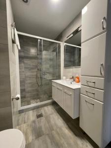 a bathroom with a shower and a sink and a toilet at Luna Apartments in Budva +55 photos