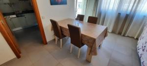 - une table et des chaises en bois dans l'établissement Apartamentos Pátio da Aldeia, à Armação de Pêra