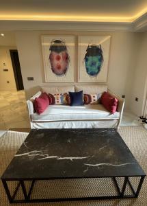 a white couch with pillows on it in a living room at Soho Boutique Castillo de Santa Catalina - Adults Recommended in Málaga