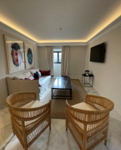 a living room with a couch and a tv at Soho Boutique Castillo de Santa Catalina - Adults Recommended in Málaga