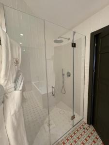 a shower with a glass door in a bathroom at Soho Boutique Castillo de Santa Catalina - Adults Recommended in Málaga