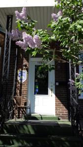 a white door with purple flowers on it at B&B Le Transit in Quebec City