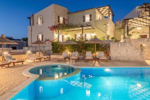 a villa with a swimming pool in front of a building at Dafni Villa, peaceful retreat, By ThinkVilla in Perama