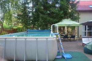a swimming pool with a ladder next to a ladder at Marta in Okuninka