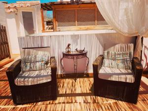 a living room with two chairs and a table at Hostal Boutique Plaza Cantarero in Nerja