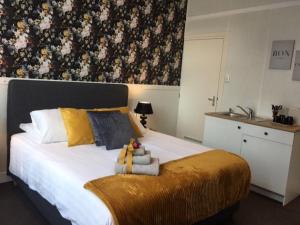 
a bedroom with a large bed and a large window at Hotel 't Witte Huys Scheveningen in Scheveningen
