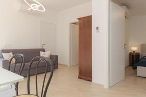 a living room with a couch and a table and chairs at Villa Pointe Alègre in Grimaud