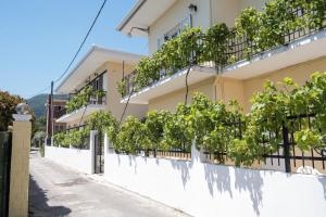een gebouw met wijnstokken aan de zijkant bij Soula Apartments in Ýpsos