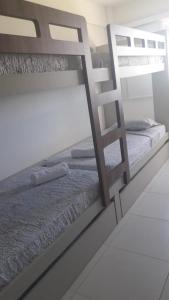 two bunk beds in a room with a ladder at Flat Polinésia Térreo Piscina Privativa in Porto De Galinhas +29 photos