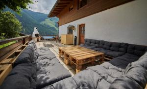 a living room with a couch and a wooden table at Delfi Ski & Bike Appartements in Saalbach Hinterglemm