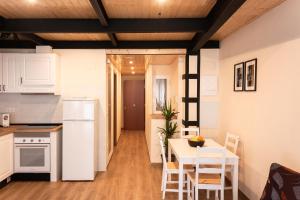 a kitchen and dining room with a table and chairs at Marittimo Apartments in Valencia