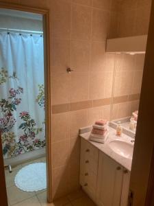 W łazience znajduje się umywalka oraz prysznic z zasłoną prysznicową. w obiekcie Borde lago I - II -III w mieście Puerto Varas