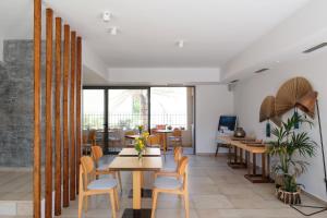 a dining room with a table and chairs at Margo Beach Hotel in Gythio