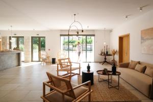 a living room with a couch and chairs at Margo Beach Hotel in Gythio