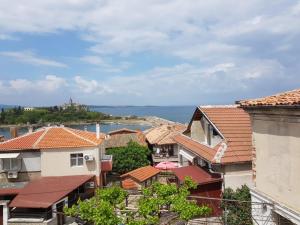 a view of roofs of houses and the ocean at Guest House Antique in Sozopol