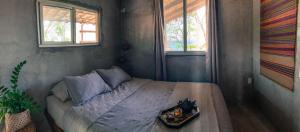 a bedroom with a bed with a tray on it at Breathe Healing & Wellness in Cambutal