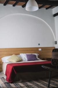 a bed in a room with a white bedspread at Podere Castellare in Pelago