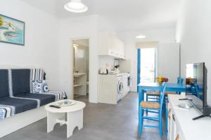 a living room with a couch and a table at Blue Moon Apartments in Makry Gialos