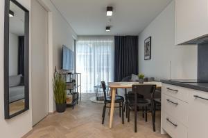 a kitchen and dining room with a table and chairs at Green Hill in Juodkrantė