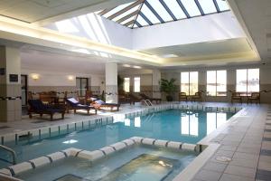 a large swimming pool in a hotel lobby at The Madison Concourse Hotel in Madison