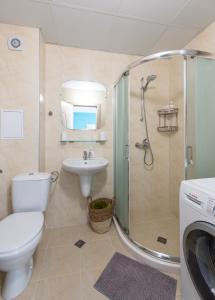 a bathroom with a shower and a toilet and a sink at Turquoise in Pomorie