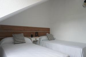 Łóżko lub łóżka w pokoju w obiekcie Hostal La Biela 43