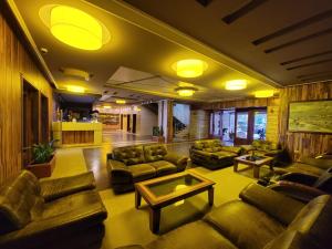 a lobby with couches and a table in a building at Hotel Enkelana in Pogradec