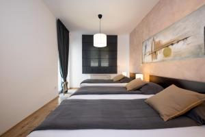 a row of four beds in a room at Villa Vires in Labin +37 photos