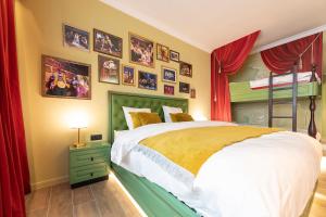 a bedroom with a bed and pictures on the wall at Plopsa Hotel in De Panne