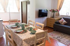 a living room with a table with chairs and a couch at Pardubsky Apartments in Ljubljana