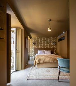 a bedroom with a bed and a brick wall at toctoctoc lisboa in Lisbon