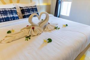 two swans made out of towels on a bed at Honeybee Pool Villa Smooth as Silk in Ao Nang Beach +32 photos