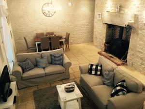 
a living room filled with furniture and a fireplace at Le Logis de Limalonges in Limalonges
