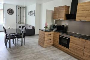 a kitchen with a table and a dining room at Vierzon superbe appartement in Vierzon