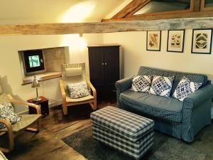 a living room with a couch and a chair at Le Logis de Limalonges in Limalonges