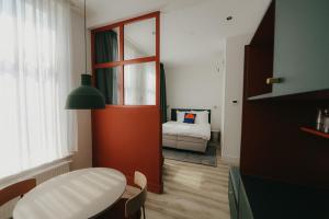 a room with a door and a bedroom with a bed at Hotel Bries Den Haag - Scheveningen in The Hague