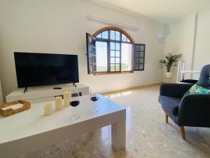 A television and/or entertainment centre at Villa Carolina with private pool