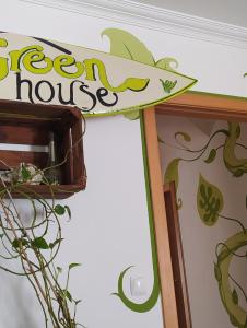 a sign for a green house on a wall at Green House in Baleal