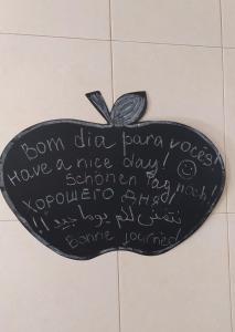 a heart shaped sign on a bathroom floor with writing on it at Green House in Baleal