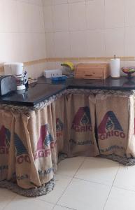 a kitchen with a counter top with bags on it at Green House in Baleal